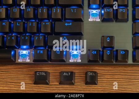 Three keys - Control Alt Delete lie next to the black keyboard on the table Stock Photo