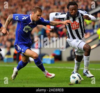 25th September 2010 - Premier League Football - West Brom Albion Vs Bolton - WBA's Somen Tchoyi gets into a race for the ball with Bolton's Gretar Rafn Steinsson.  Photographer: Paul Roberts / OneUpTop/Alamy. Stock Photo