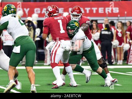 Dec 07, 2019: Oklahoma Sooners quarterback Jalen Hurts #1 is sacked in the second quarter by Baylor Bears defensive tackle James Lynch #93 during the NCAA Big 12 Championship game between the Baylor University Bears and the University of Oklahoma Sooners at AT&T Stadium in Arlington, TX Albert Pena/CSM Stock Photo