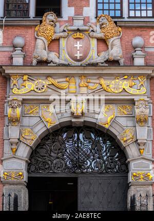 Beautiful decorated in gold, historic door portal of Great Arsenal in Gdansk, Poland Stock Photo