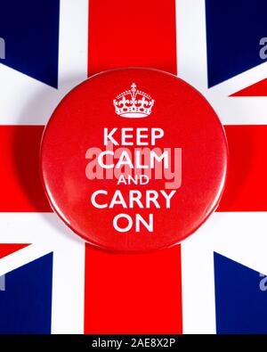 London, UK - November 22nd 2019: Keep Calm and Carry On symbol, pictured over the flag of the United Kingdom. Stock Photo