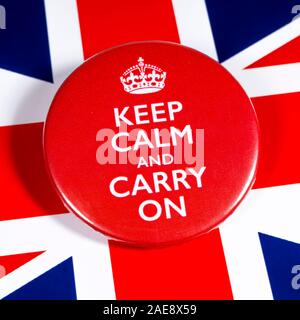 London, UK - November 22nd 2019: Keep Calm and Carry On symbol, pictured over the flag of the United Kingdom. Stock Photo