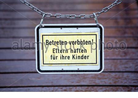 A No Trespassing sign in German which also says parents are responsible for their children. Stock Photo