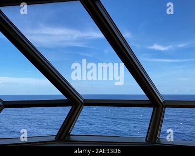 A cruise ship window overlooking the blue Atlantic Ocean. Stock Photo