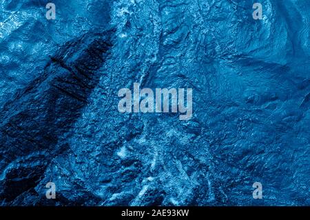 Texture of blue ripply sea water flowing surface background. Trendy color of the year 2020. Stock Photo