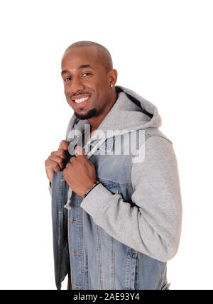 A close up image of a young African American man standing in a jeans jacket in profile, isolated for white background Stock Photo