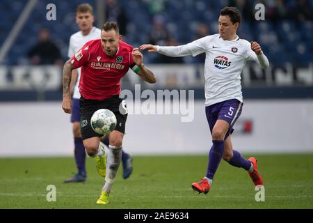 Hanover, Germany. 07th Dec, 2019. Soccer: 2nd Bundesliga, Hannover 96 - Erzgebirge Aue, 16th matchday in the HDI-Arena. Hanover's Marvin Bakalorz (l) plays against Aues Clemens Fandrich. Credit: Swen Pförtner/dpa - IMPORTANT NOTE: In accordance with the requirements of the DFL Deutsche Fußball Liga or the DFB Deutscher Fußball-Bund, it is prohibited to use or have used photographs taken in the stadium and/or the match in the form of sequence images and/or video-like photo sequences./dpa/Alamy Live News