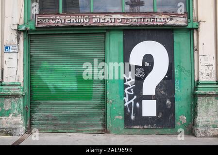 Big interrogation question mark in black and white mural poster on old vintage closed down shop Stock Photo