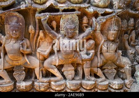 Bas relief carvings of Dvarapalas, human or demonic temple guardians, generally armed with lances and clubs. Their function is to protect the temples. Stock Photo