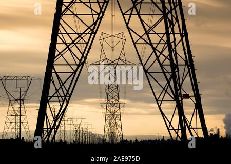 Eletrical towers and power lines close to sunset in north Idaho. Stock Photo