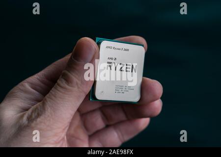 Valencia, Spain - December 07, 2019: Hand holding AMD Ryzen 3600 processor. New coonsumer  Zen 2, 7 nanometer desktop CPU by AMD. Very popular 3rd gen Stock Photo