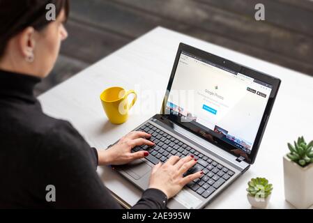 Sarajevo, Bosnia and Herzegovina - December 7, 2019: Girl use Google Photos service for photo sharing on laptop computer Stock Photo