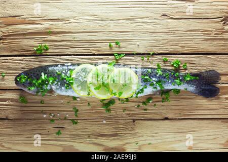 Whole Raw Trout With Lemons And Parsley Stock Photo