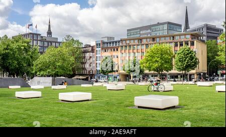 White benches in Domplatz garden the original site of Hamburg Cathedral in Altstadt Hamburg Germany Stock Photo