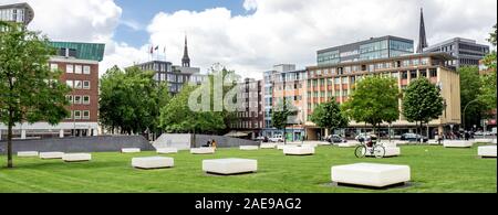 White benches in Domplatz garden the original site of Hamburg Cathedral in Altstadt Hamburg Germany Stock Photo