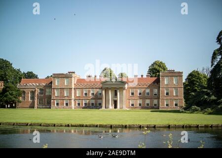 North face of The Vyne, built 1500-1520, behind the lake created from Shir brook. Showing lawns and classical portico added in 1654 by John Webb. Stock Photo
