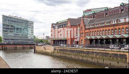 New office building and Former Main Customs Office on either side of Zoll Canal in Speicherstadt Warehouse District Altstadt Hamburg Germany Stock Photo