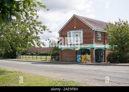 Burghfield Pharmacy and Auclum Green. Reading Road, Burghfield Common - Community Pharmacy in village location, next to community playground/park Stock Photo