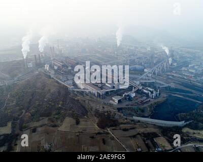 Aerial view of big factory in China. Air pollution by smoke coming out of chimneys. Coal Fossil Fuel Power Plant Smokestacks Emit Carbon Dioxide Pollution. Chengde, China. December, 12th, 2019 Stock Photo