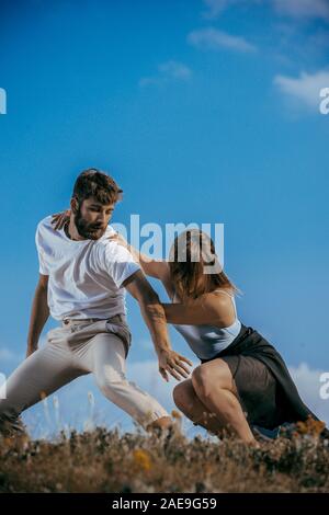 Two athletic young dancers making a performance at mountain peak Stock Photo