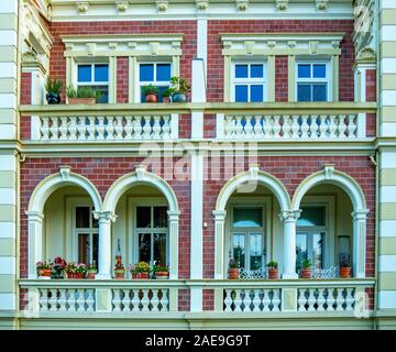 Ornate and decorative plaster cornices arches portico balustrades and facade of a traditional house in Cuxhaven Lower Saxony Germany. Stock Photo