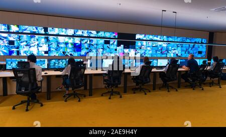 Team of secret agents in uniforms, monitoring cyber, video and communications at the main control data center station. Stock Photo