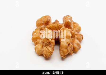 One peeled walnut on a white background. Stock Photo