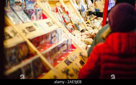 Strasbourg, France - Dec 20, 2016: Side view of people shopping at the market stalls for traditional gifts and toys Stock Photo