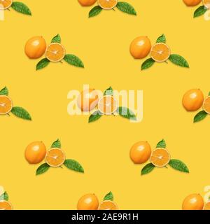 Seamless pattern with Meyer lemon and green leaves on yellow background. Fruit pattern. Tropical abstract background. Minimal fruit concept. Stock Photo