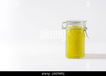 Homemade delicious green jam in glass jar on white background. Copy space. Side view. Stock Photo