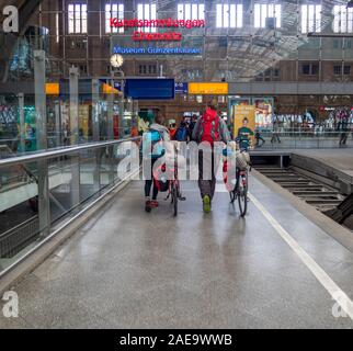 Touring cyclists and other passengers on platform of Leipzig Hauptbahnhof Central Train Station Leipzig Saxony Germany Stock Photo