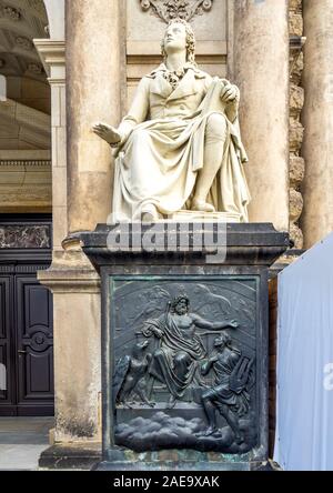 Statue of Friedrich von Schiller on plinth with bronze relief of Zeus entrance to Semperoper Dresden Opera house Dresden Saxony Germany. Stock Photo