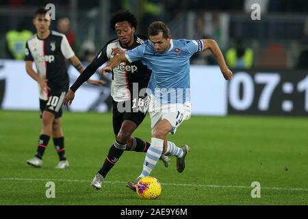 Rome, Italy. 07th Dec, 2019. Senad Lulic of Lazio and Juan Cuadrado (Juventus) compete for the ball during the Serie A TIM match between SS Lazio and Juventus FC at Stadio Olimpico on December 7, 2019 in Rome, Italy. Lazio beat Juventus by 3-1 during the 15 round of Serie A (Photo by Giuseppe Fama/Pacific Press) Credit: Pacific Press Agency/Alamy Live News Stock Photo