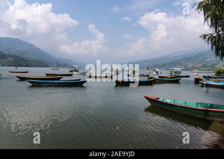 Phewa Lake a Cloudy Day and wooden color Boats Stock Photo