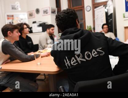 Munich, Germany. 28th Nov, 2019. Members of 'HEROES Munich' talk in their office. HEROES is a project for equal rights in which young men from cultures of honour are engaged against oppression in the name of honour and for equal rights and equality between women and men. Credit: Angelika Warmuth/dpa/Alamy Live News Stock Photo