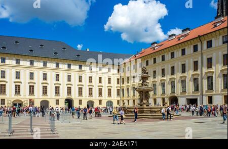 Tourists in the Second Courtyard of the Prague Castle Complex Administration Palace Building and Royal Stables Prague Czech Republic.
