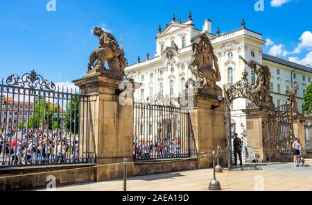 Tourists outside the Wrestling Titans or Giants' Gate entrance to the First Courtyard of the Prague Castle Complex  Prague Czech Republic. Stock Photo