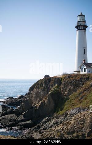 Pigeon Point Lighthouse and Lighthouse Keepers Cottage perched on cliff top bluff overlooking the Pacific Ocean in Northern California. Stock Photo