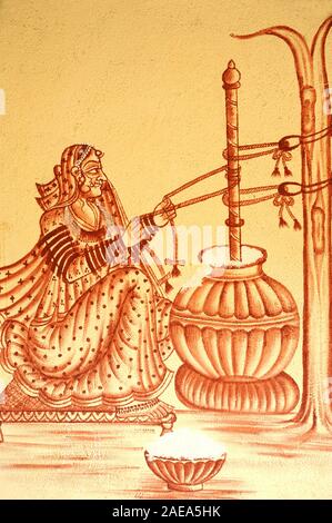 Mumbai, Maharashtra, India- Asia,  Nov. 2015 - Illustration on wall Rural Indian  woman churning butter milk traditional way. Stock Photo