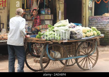 A vegetables seller with his cart on the road of  Varanasi Stock Photo