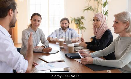 Concentrated group of diverse business partners discussing development strategy. Stock Photo
