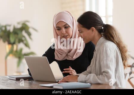 Focused team leader training millennial female intern. Stock Photo