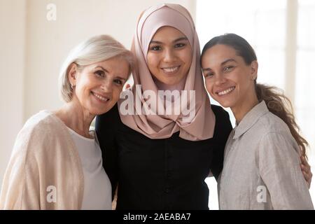 Multiracial diverse female coworkers international team posing for photo. Stock Photo