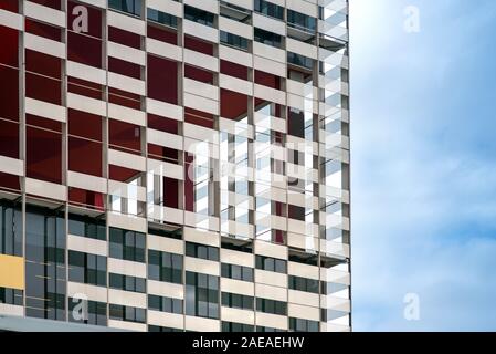 Exterior facade of a modern apartment or office block in close up detail against a hazy blue sky Stock Photo