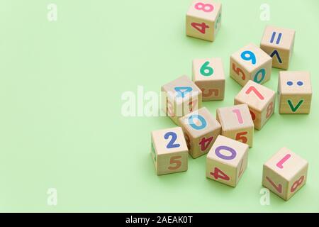 Wooden cubes with numbers on light green background Stock Photo