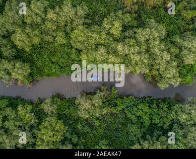 Aerial view of boat in the mangrove Rio Sierpe river in Costa Rica deep inside the jungle.