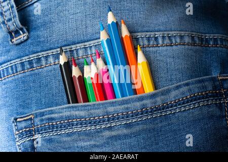 Colored sharpened pencils in jeans pocket, closeup. Stock Photo