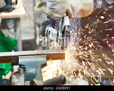 Metal cutting with angle grinder with sparks Stock Photo