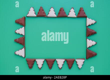 Pattern of chocolate Christmas trees. Rectangular frame. Minimalistic christmas background. Flat lay. Copy spase. Top view. Stock Photo
