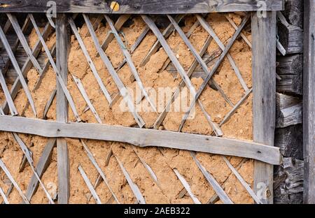 Old log wall. Texture of the wooden wall of an old house. Close up. Stock Photo